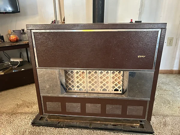 Vintage Cozy brand gas room heater standing in a carpeted living room